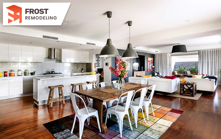 Open-concept kitchen seamlessly integrated with dining area, showcasing a bright and airy layout with contemporary finishes